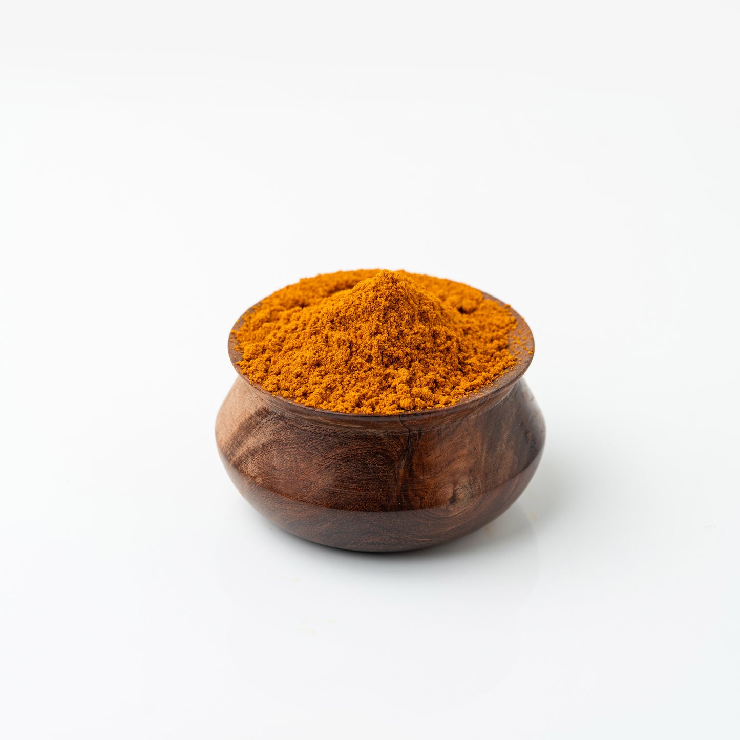 Wooden bowl filled with Azhli Vidhai Menas (Flax Seeds Podi) on a white background