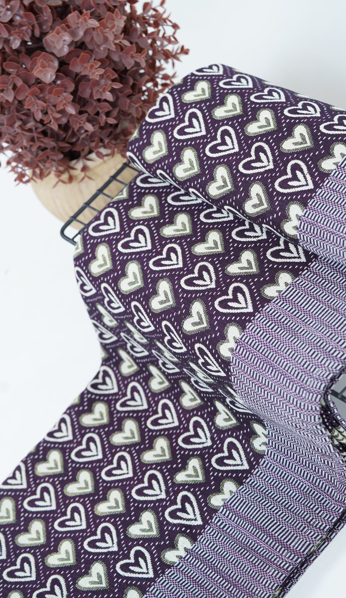 Close-up of a purple Premium Handloom double cot Chennimalai bedsheet with heart pattern on a white background