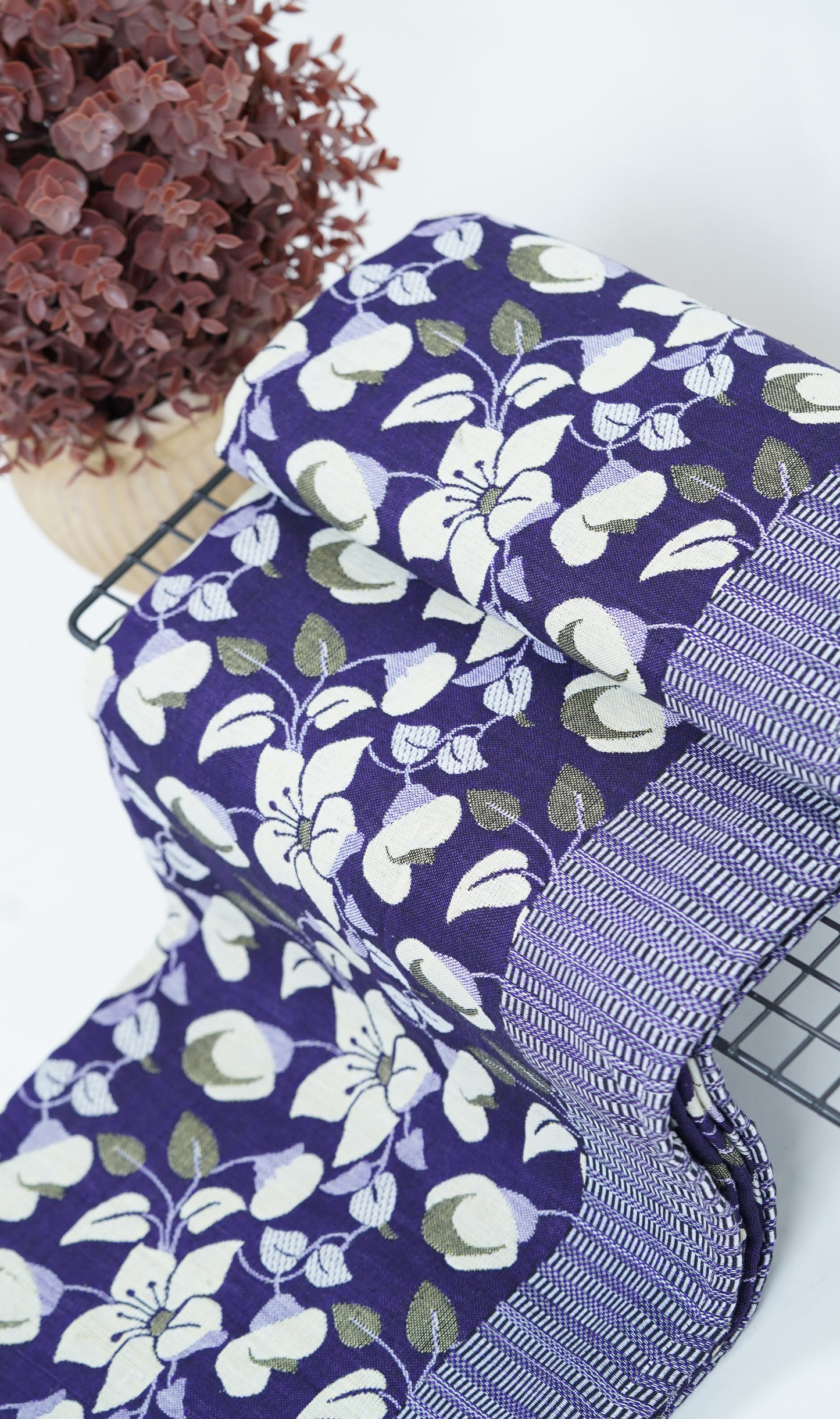Floral-patterned Premium Handloom double cot Chennimalai bedsheet with a purple ribbon on a white background