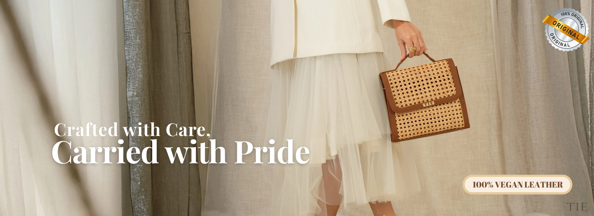 Person holding a woven handbag with text 'Crafted with Care. Carried with Pride' and '100% Vegan Leather' label.