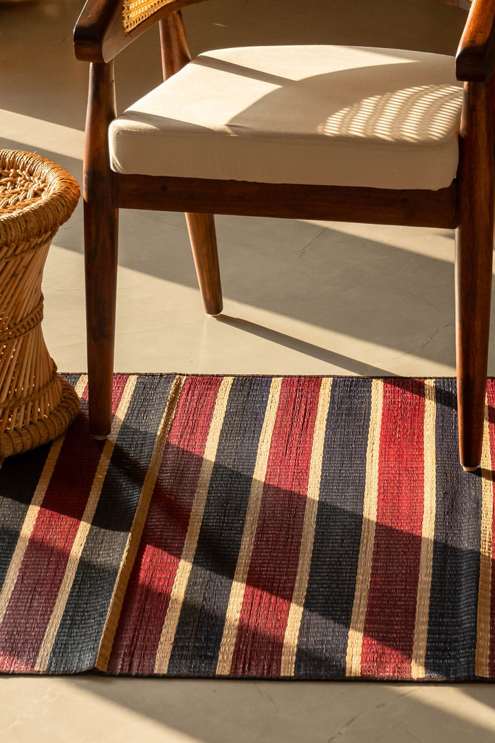 Wooden chair with a cushion on a striped Pattamadai pai