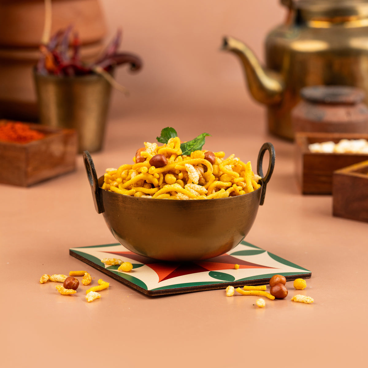 A bowl of Aval Mixture (Poha Mixture) on a table, consisting of crispy rice flakes with roasted nuts and spices.