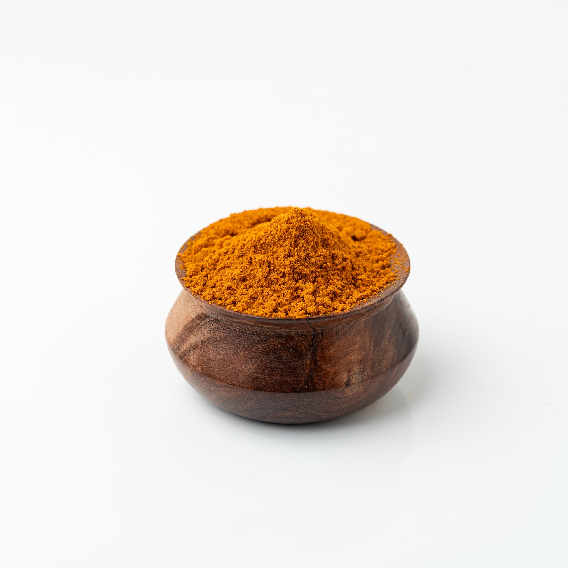 Wooden bowl filled with Azhli Vidhai Menas (Flax Seeds Podi) on a white background