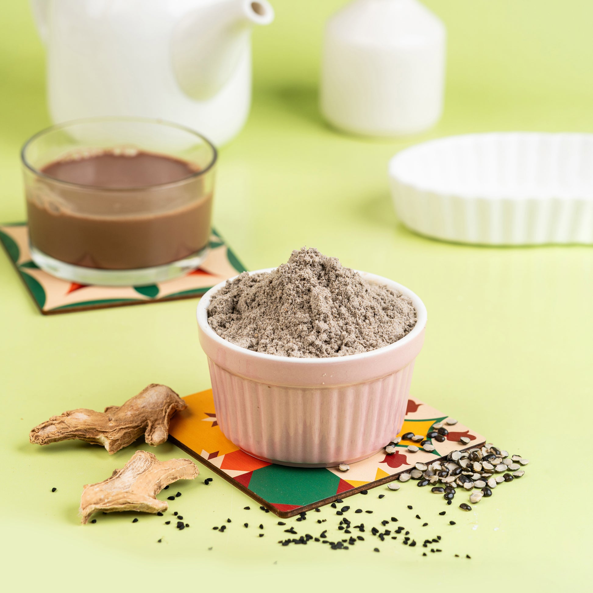 A bowl of Bone Health Porridge mix in a white bowl with ingredients like millet and seeds visible, served with a side of ginger.