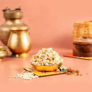 A bowl of air fried cholam (millet) sweet on a colorful surface, with a backdrop of golden-brown textures and a beige lid.