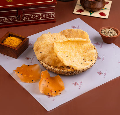 Sun-dried spicy snack served on a basket with spices in the background, presented on a table with a decorative cloth.