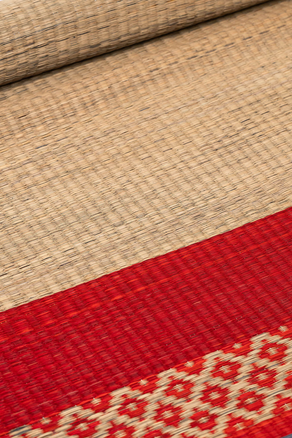 Close-up of woven fabric with a red and beige pattern