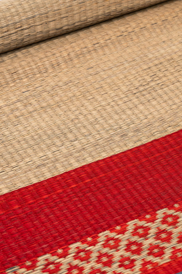 Close-up of woven fabric with a red and beige pattern