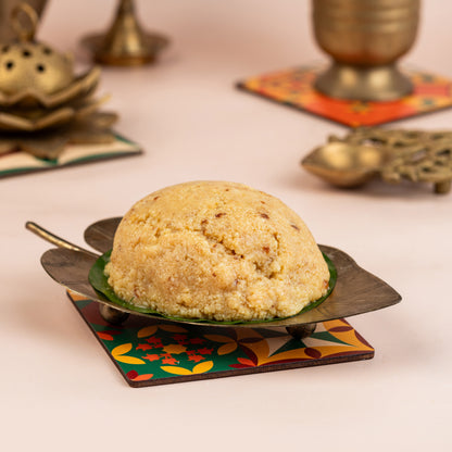 Decorative cake on a leaf-shaped plate with traditional decor in the background