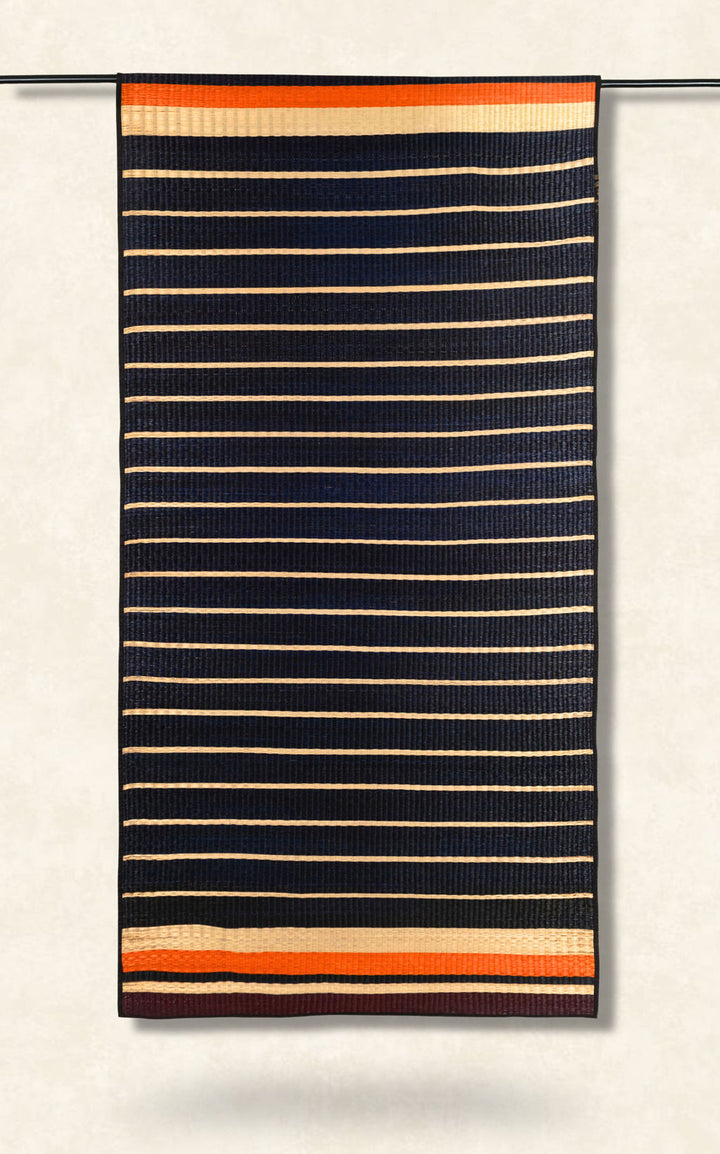 Striped fabric with black, orange, and beige pattern on a white background