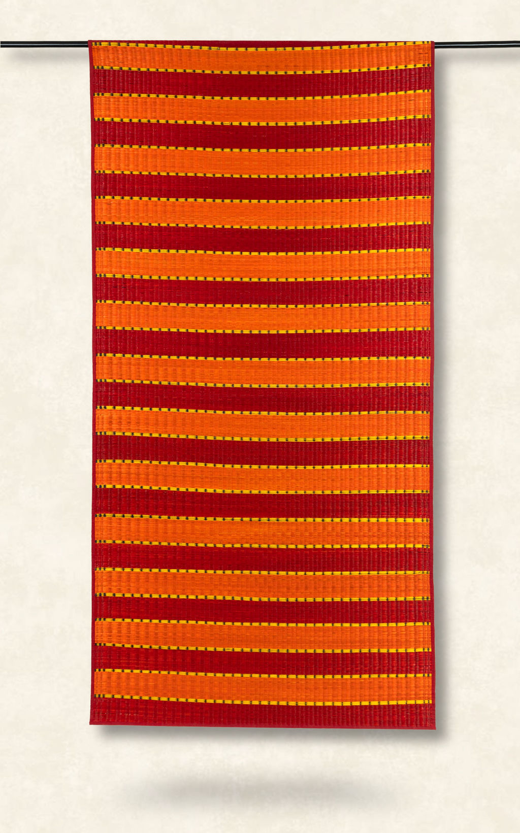Red and orange striped fabric on a white background