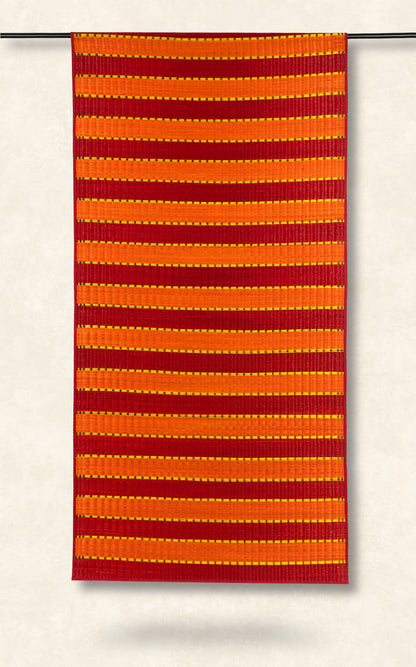 Red and orange striped fabric on a white background