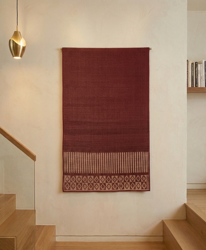 Virutcham Pattamadai Pai hanging on a white wall in a modern interior setting.