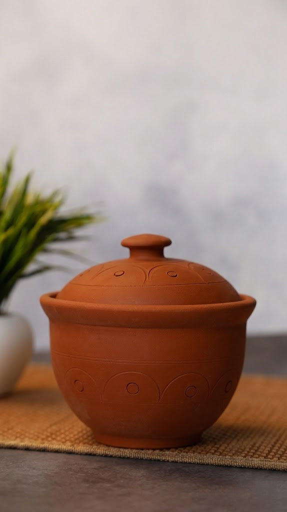 Curd Pot with Lid on a woven mat with a blurred background