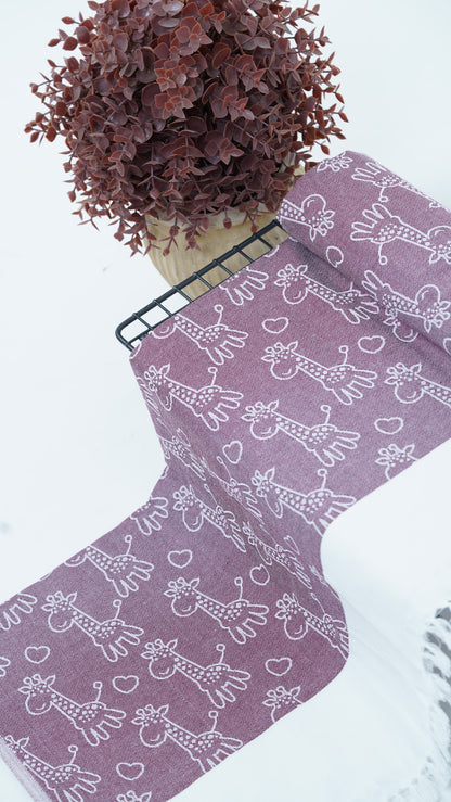Purple bedsheet with white animal pattern on a white surface