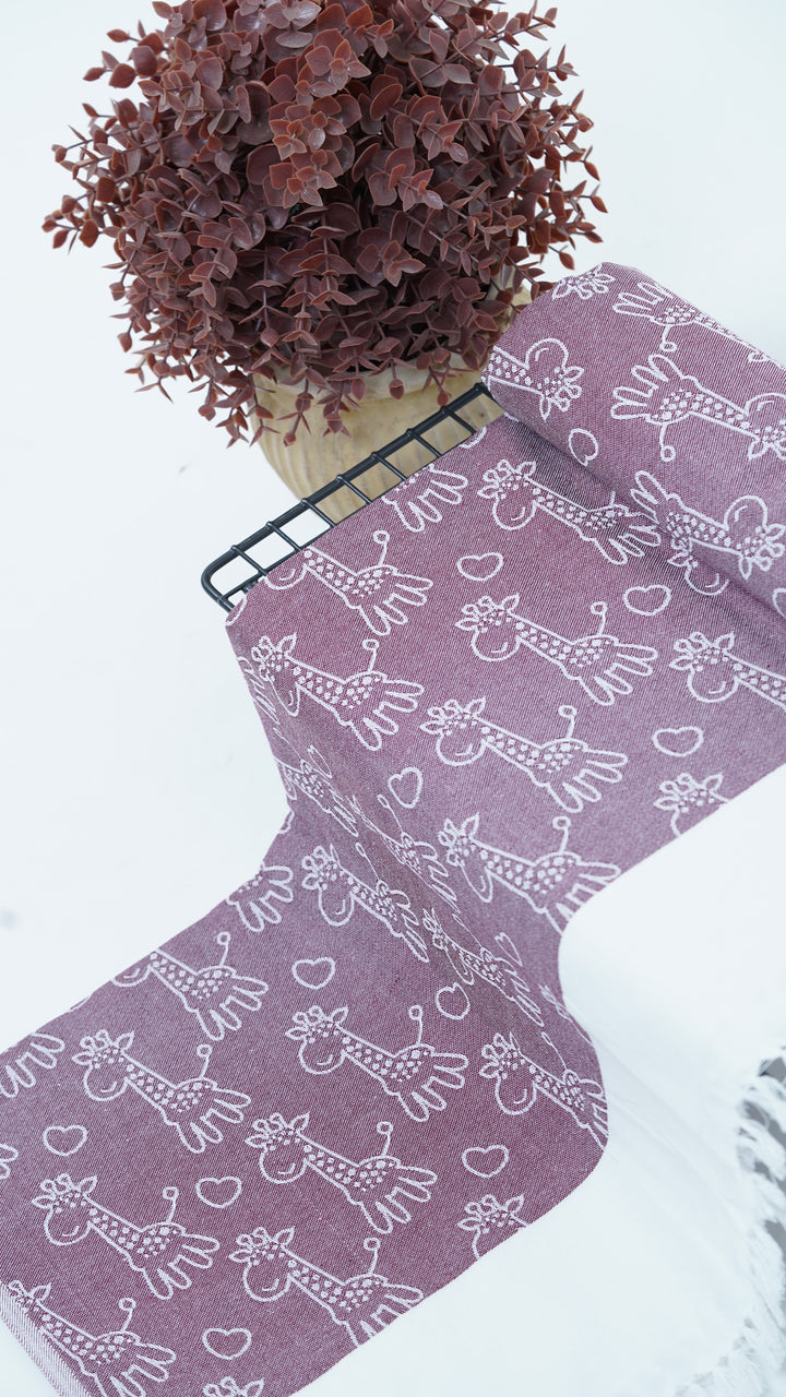 Purple bedsheet with white animal pattern on a white surface