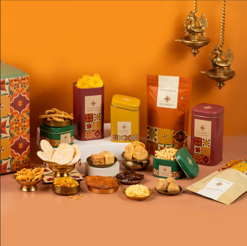 Assorted snacks and treats displayed on a table with an orange wall background