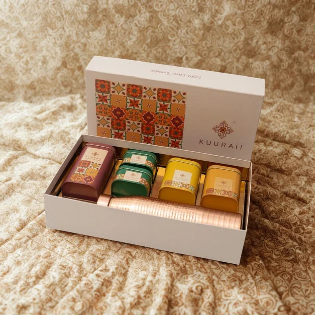 Gift set with colorful containers in a box labeled 'Kuuraii' on a textured surface.