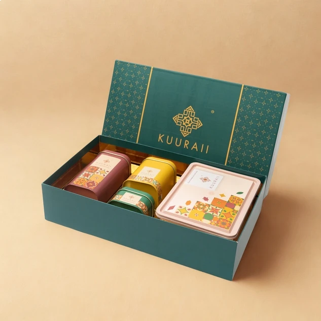 Open teal gift box with three small containers and a card inside, featuring the brand 'KUURAII'.