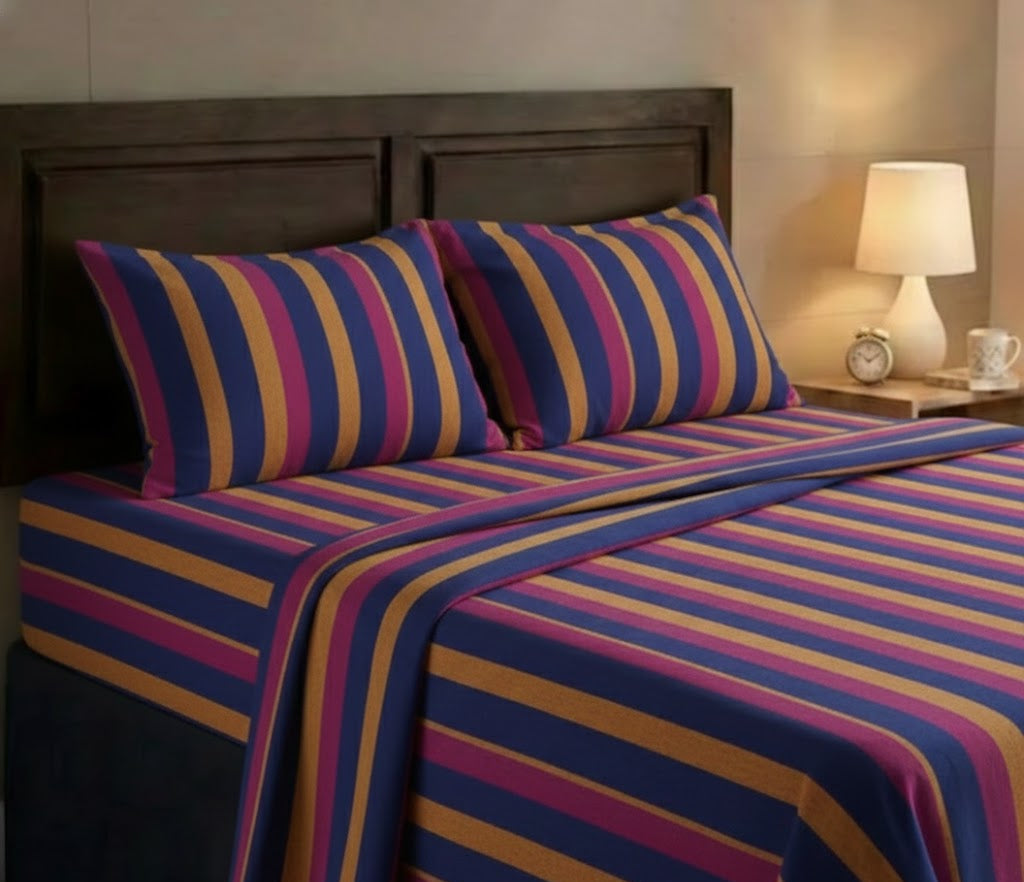 Striped Chennimalai Double Cot Bedspread Classic Blue & Pink with colorful pattern on a bed in a bedroom setting.