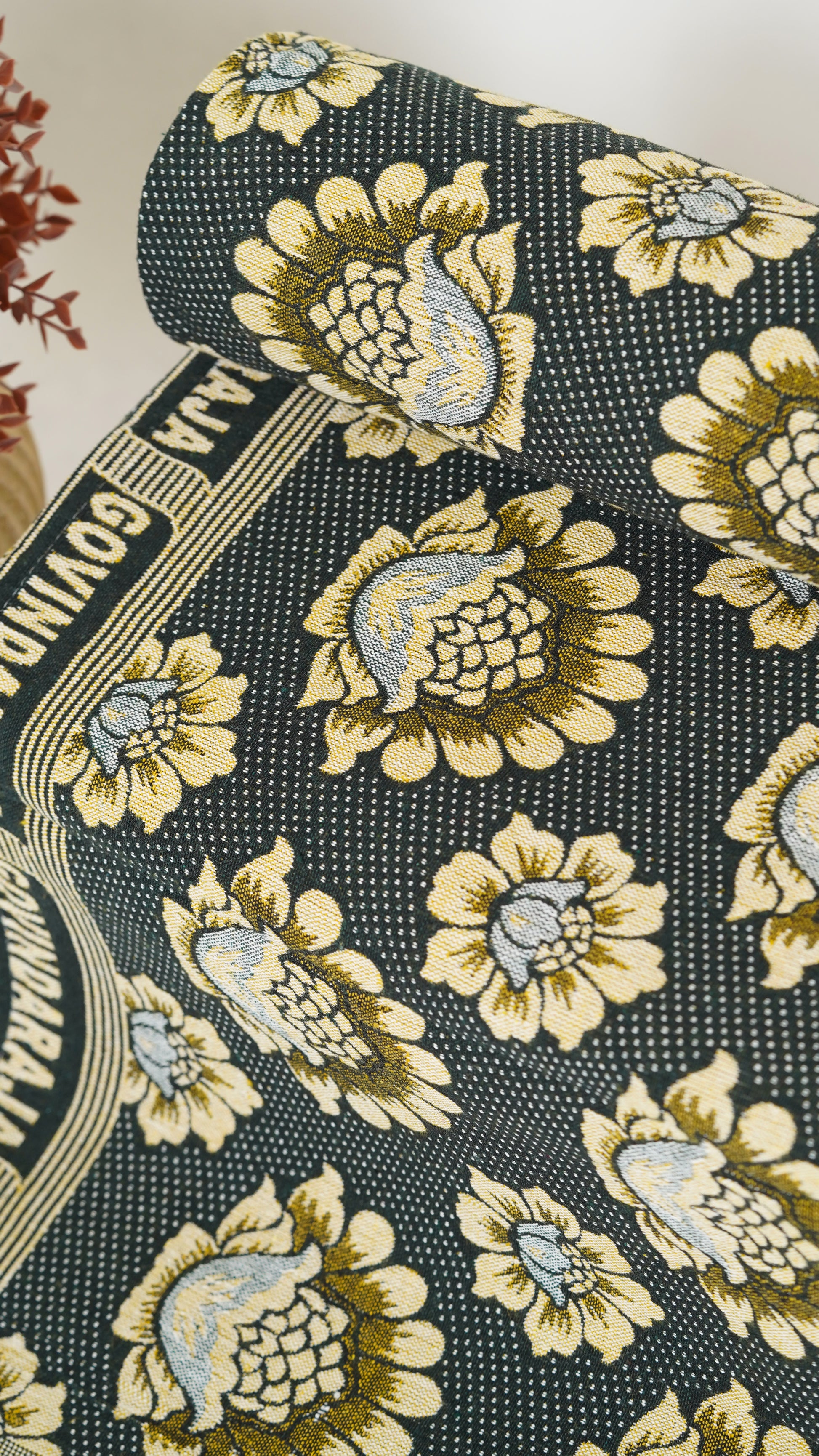 Floral patterned fabric with a visible brand name on a textured background