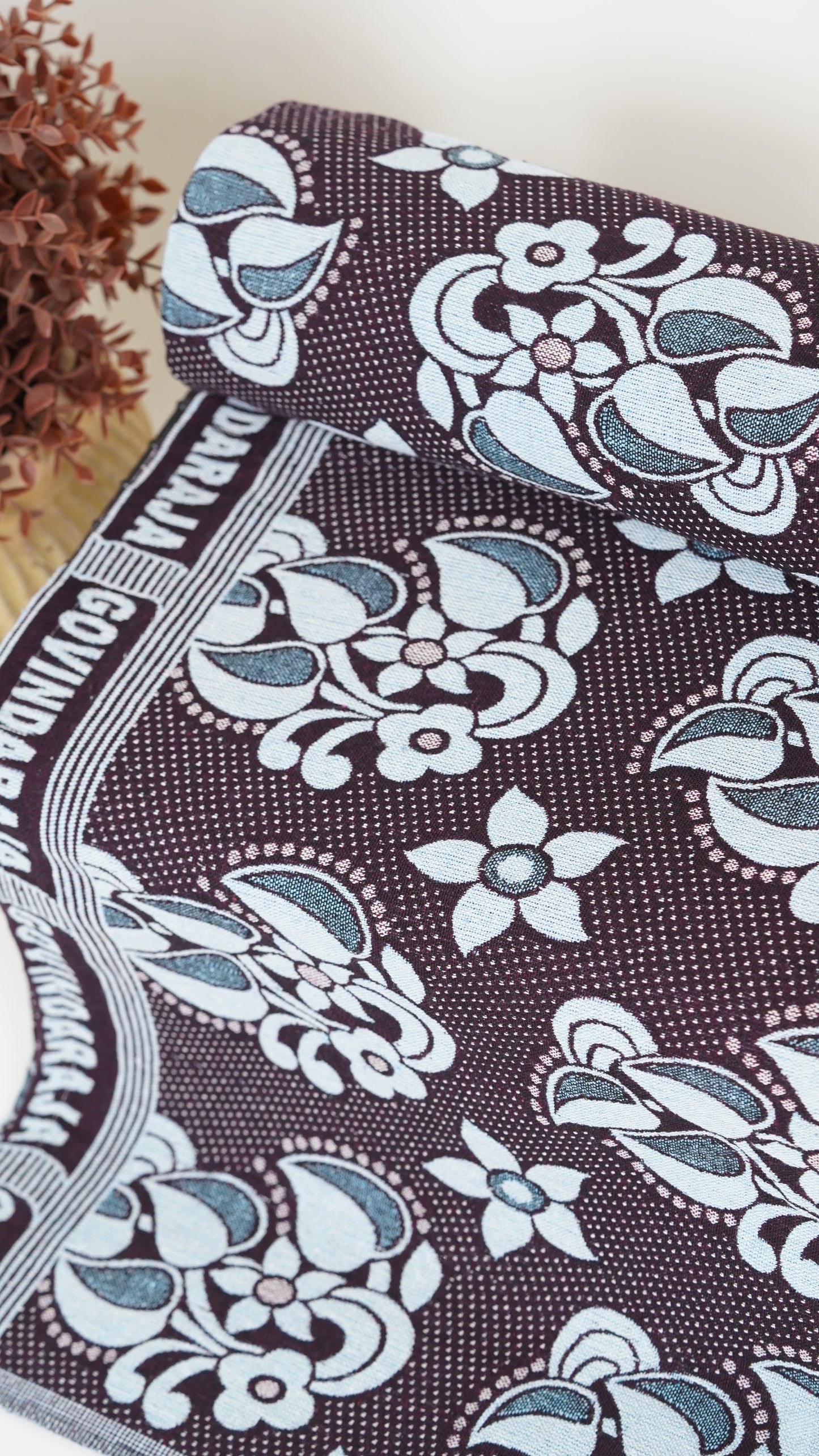 Floral patterned fabric with white flowers on a brown background