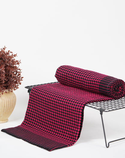 Red and black checkered blanket on a chair with a white background